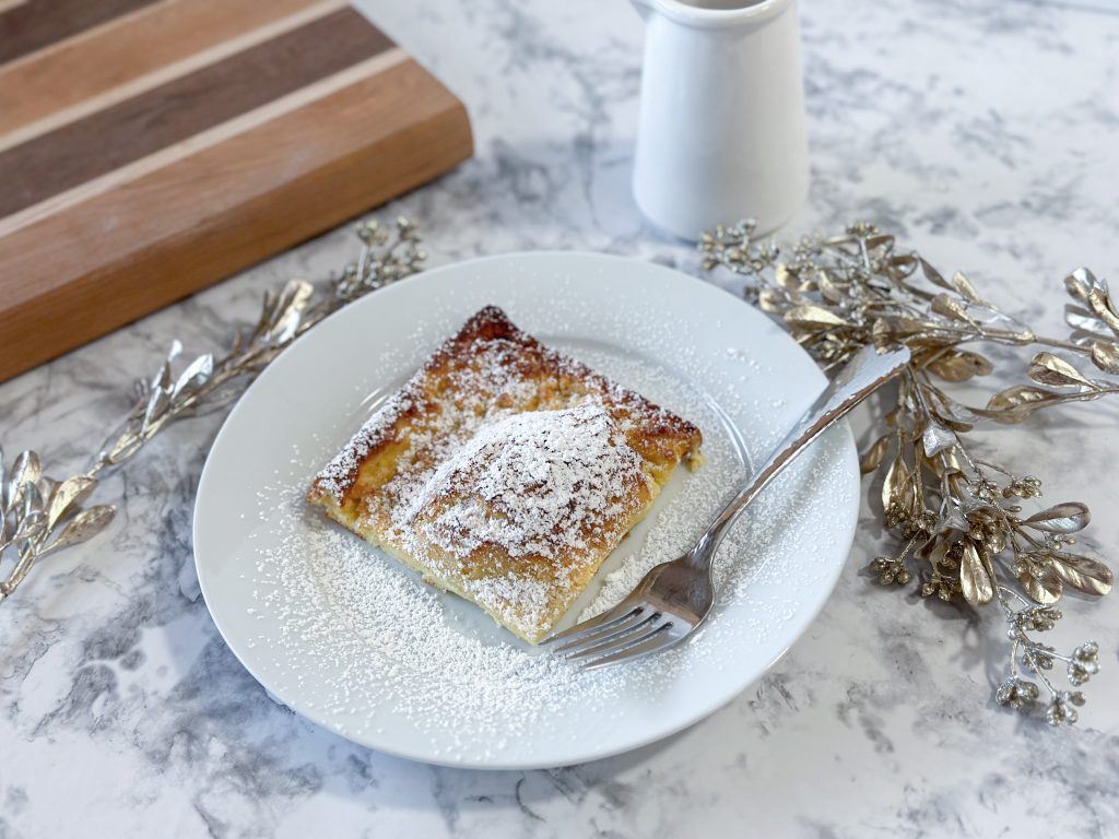Picture of a slice of Sourdough german pancake with powdered sugar topping