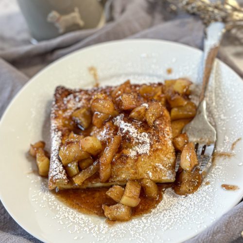 Image of a slice of German pancake with caramelized apple topping