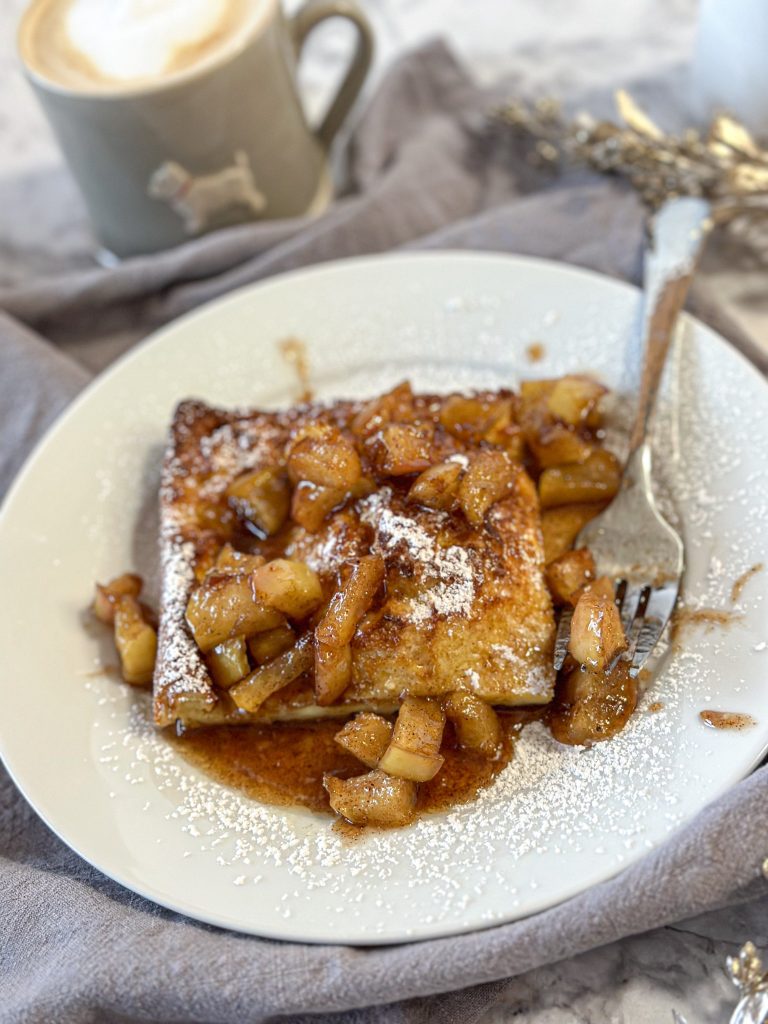 Image of a slice of German pancake with caramelized apple topping